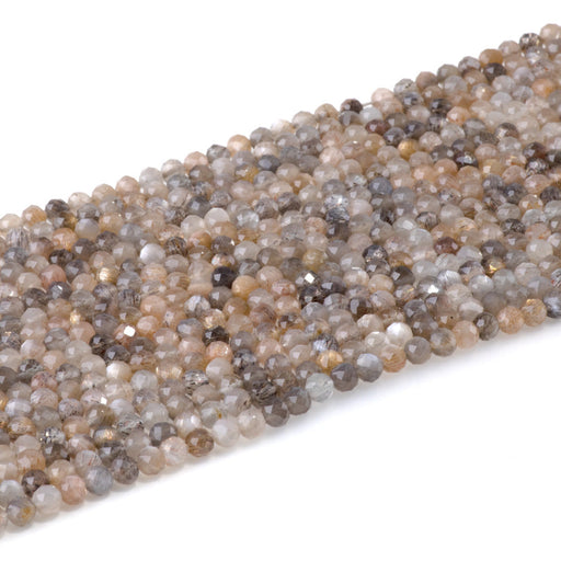 This is a Dakota Stones 4mm Peach Black Moonstone Microfaceted Gemstone strand with round beads in 15-16 inch strand.