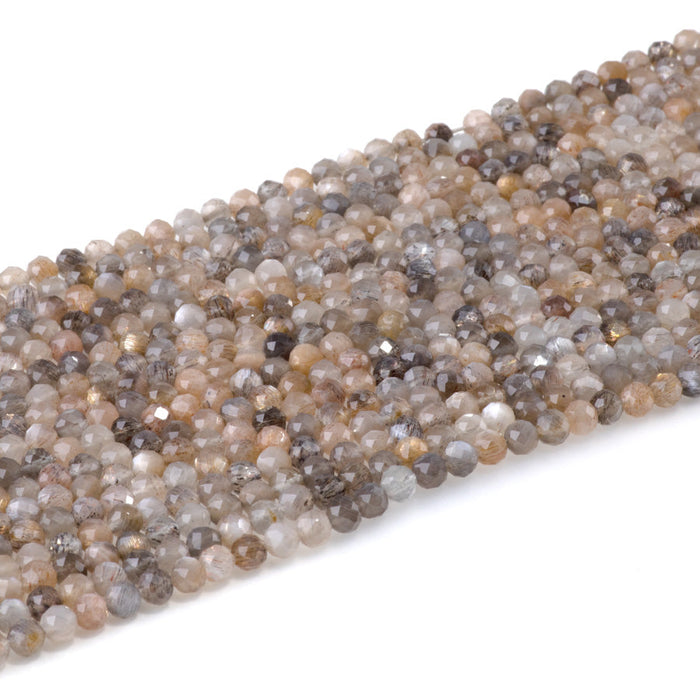 This is a Dakota Stones 4mm Peach Black Moonstone Microfaceted Gemstone strand with round beads in 15-16 inch strand.