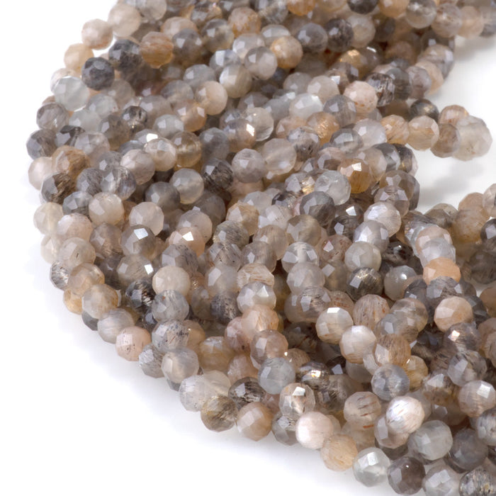 This is a Dakota Stones 4mm Peach Black Moonstone Microfaceted Gemstone strand with round beads in 15-16 inch strand.