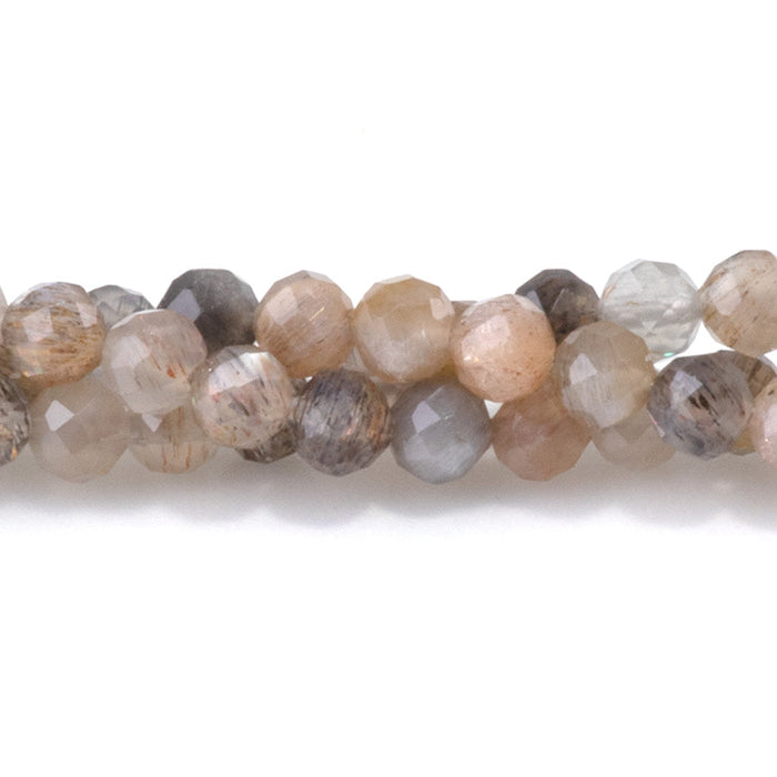 This is a Dakota Stones 4mm Peach Black Moonstone Microfaceted Gemstone strand with round beads in 15-16 inch strand.