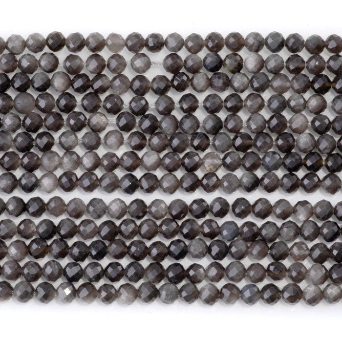 This is a Dakota Stones 4mm Silver Obsidian Microfaceted Gemstone strand with round beads in 15-16 inch strand.