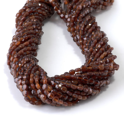 This is a Dakota Stones 4mm Orange Garnet Gemstone strand with faceted coin beads in 15-16 inch strand.