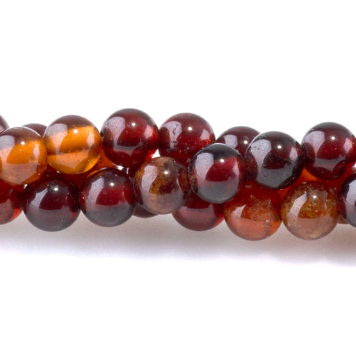 This is a Dakota Stones 4mm Orange Garnet Gemstone strand with round beads in 8 inch strand.