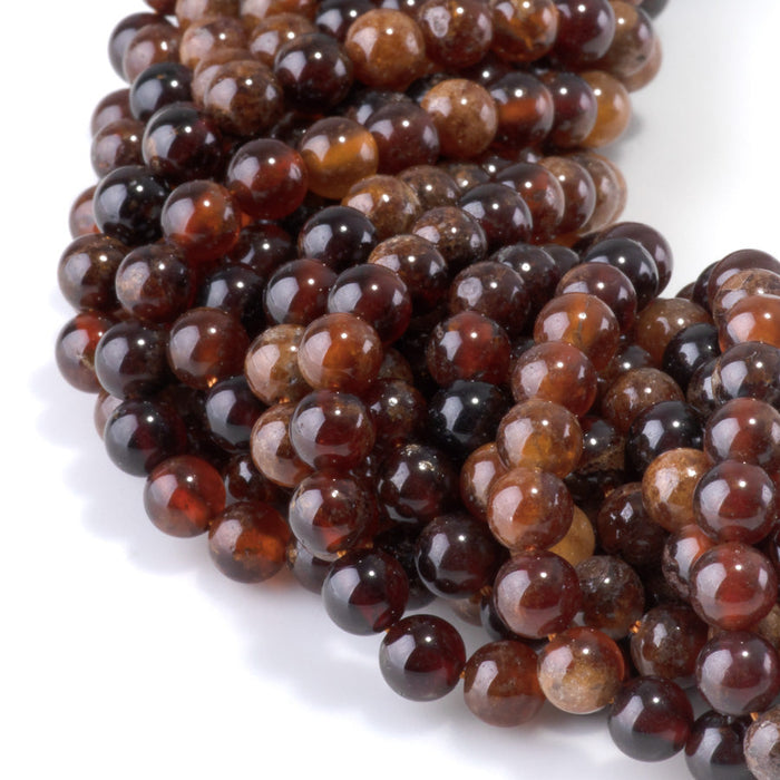 This is a Dakota Stones 6mm Orange Garnet Gemstone strand with round beads in 15-16 inch strand.