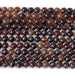 This is a Dakota Stones 6mm Orange Garnet Gemstone strand with double heart faceted round beads in 15-16 inch strand.