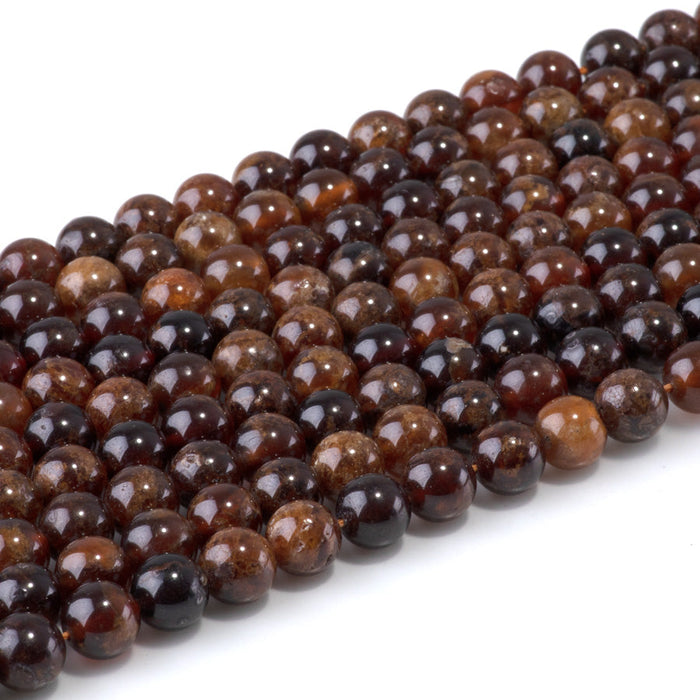 This is a Dakota Stones 8mm Orange Garnet Gemstone strand with round beads in 15-16 inch strand.