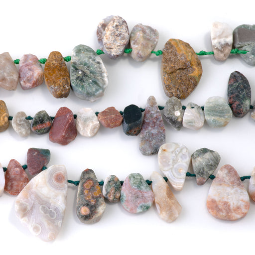 This is a Dakota Stones 8x12-13x18mm Ocean Jasper Top Drill Pear Gemstone strand with rough beads in 15-16 inch strand.
