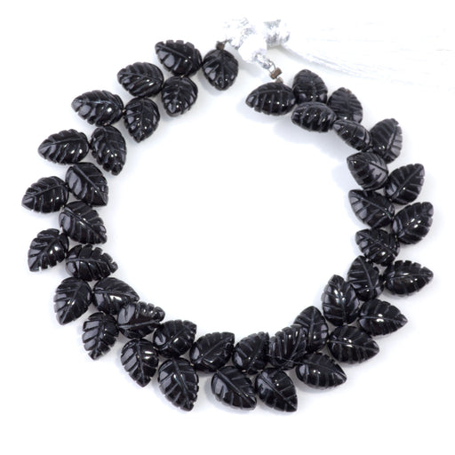 This is a Dakota Stones 8x11mm Onyx Leaf Gemstone strand of round beads in 8 inch strand.
