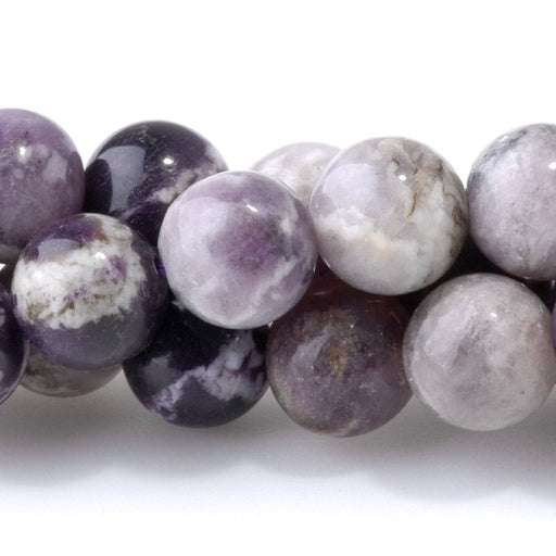 This is a Dakota Stones 8mm Purple Flower Fluorite Gemstone strand with round beads in 15-16 inch strand.