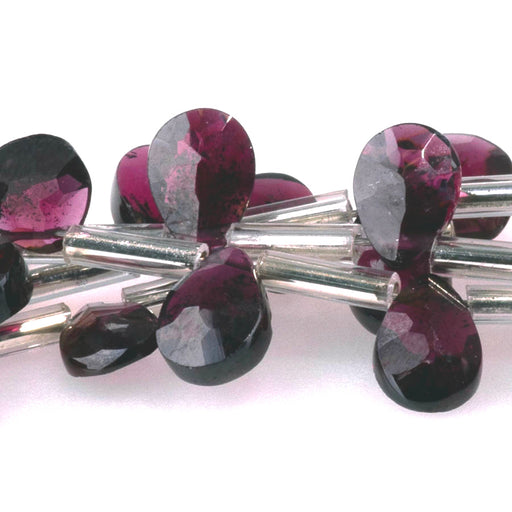 This is a Dakota Stones 6mm Purple Garnet Gemstone strand with faceted heart beads in 8 inch strand.