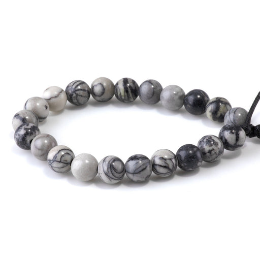 This is a Dakota Stones 10mm Black Picasso Jasper Large Hole Gemstone strand with round beads in 8 inch strand.