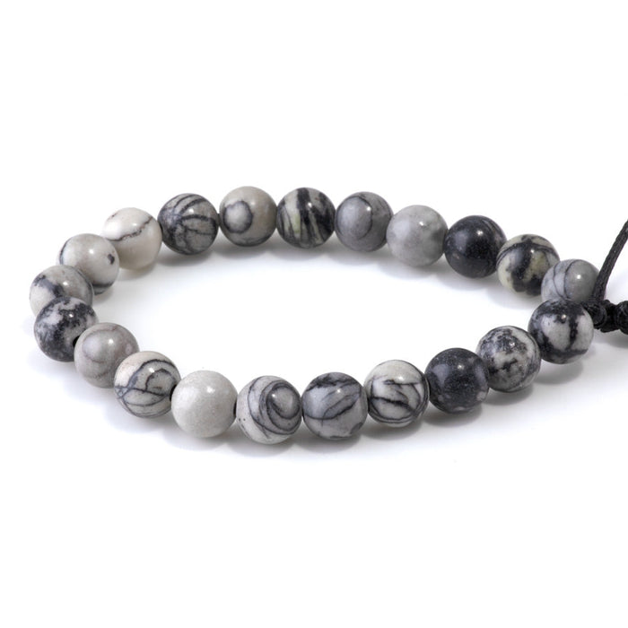 This is a Dakota Stones 10mm Black Picasso Jasper Large Hole Gemstone strand with round beads in 8 inch strand.