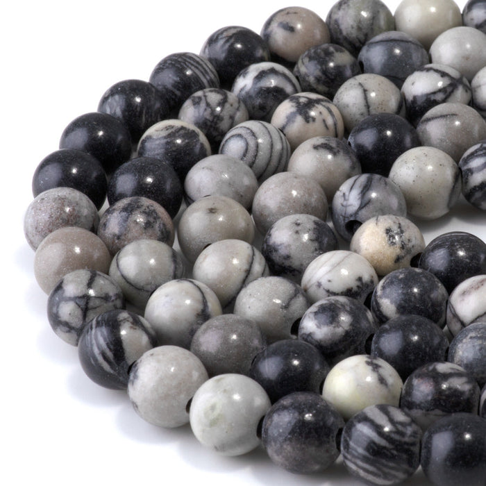 This is a Dakota Stones 10mm Black Picasso Jasper Large Hole Gemstone strand with round beads in 8 inch strand.