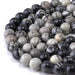This is a Dakota Stones 10mm Black Picasso Jasper Large Hole Gemstone strand with round beads in 8 inch strand.