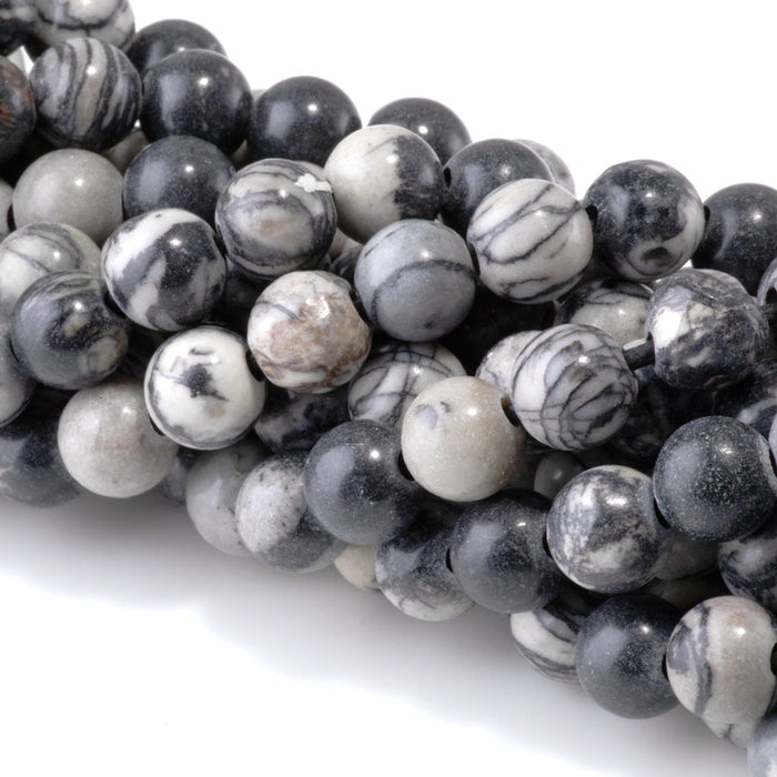 This is a Dakota Stones 10mm Black Picasso Jasper Large Hole Gemstone strand with round beads in 8 inch strand.