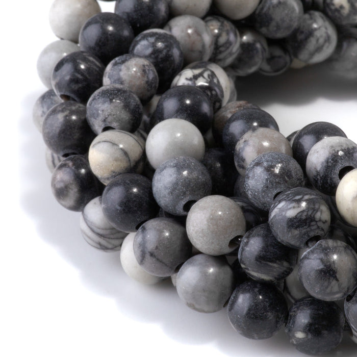 This is a Dakota Stones 10mm Black Picasso Jasper Large Hole Gemstone strand with round beads in 8 inch strand.
