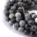 This is a Dakota Stones 10mm Black Picasso Jasper Large Hole Gemstone strand with round beads in 8 inch strand.