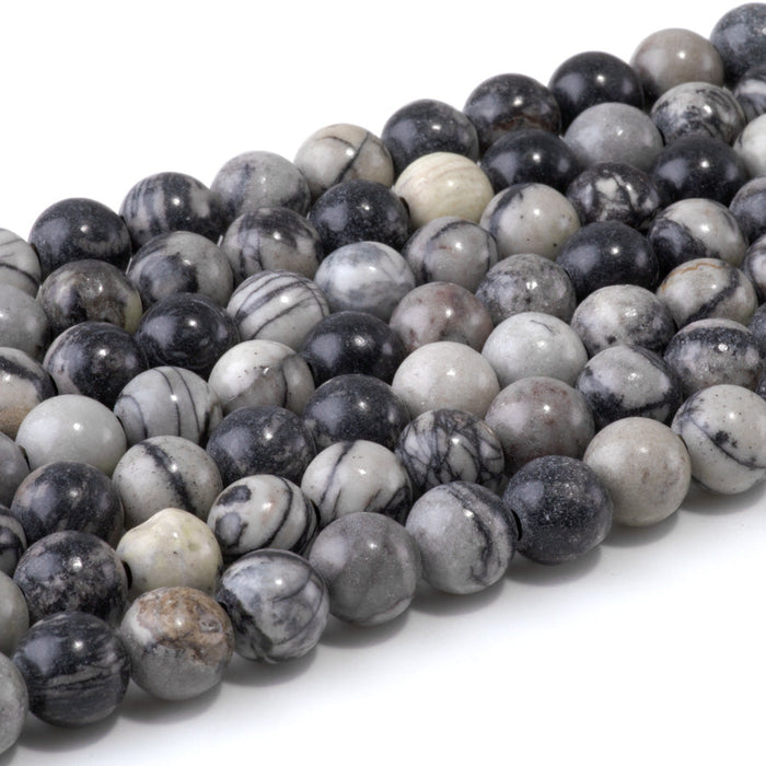 This is a Dakota Stones 10mm Black Picasso Jasper Large Hole Gemstone strand with round beads in 8 inch strand.