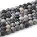 This is a Dakota Stones 10mm Black Picasso Jasper Large Hole Gemstone strand with round beads in 8 inch strand.