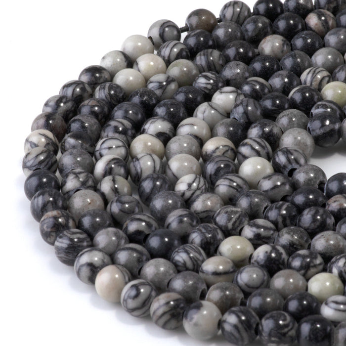 This is a Dakota Stones 6mm Black Picasso Jasper Large Hole Gemstone strand with round beads in 8 inch strand.