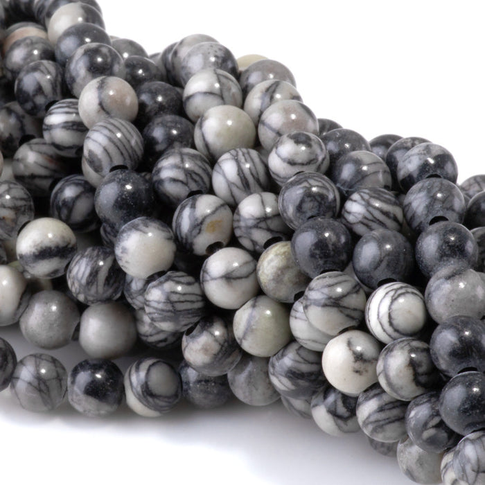This is a Dakota Stones 6mm Black Picasso Jasper Large Hole Gemstone strand with round beads in 8 inch strand.