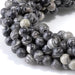 This is a Dakota Stones 6mm Black Picasso Jasper Large Hole Gemstone strand with round beads in 8 inch strand.