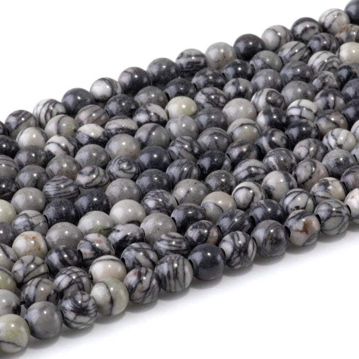 This is a Dakota Stones 6mm Black Picasso Jasper Large Hole Gemstone strand with round beads in 8 inch strand.
