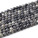 This is a Dakota Stones 6mm Black Picasso Jasper Large Hole Gemstone strand with round beads in 8 inch strand.