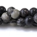 This is a Dakota Stones 6mm Black Picasso Jasper Large Hole Gemstone strand with round beads in 8 inch strand.