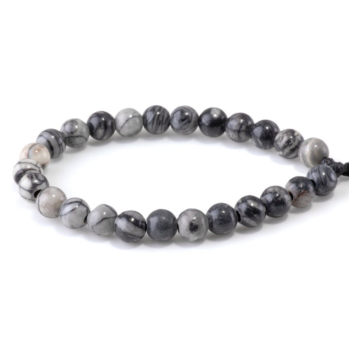This is a Dakota Stones 8mm Black Picasso Jasper Large Hole Gemstone strand with round beads in 8 inch strand.