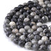 This is a Dakota Stones 8mm Black Picasso Jasper Large Hole Gemstone strand with round beads in 8 inch strand.