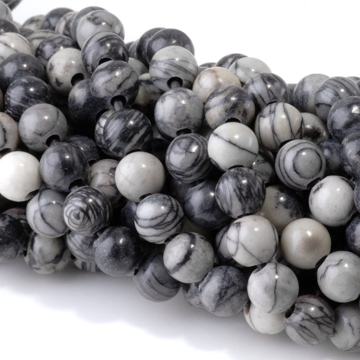 This is a Dakota Stones 8mm Black Picasso Jasper Large Hole Gemstone strand with round beads in 8 inch strand.