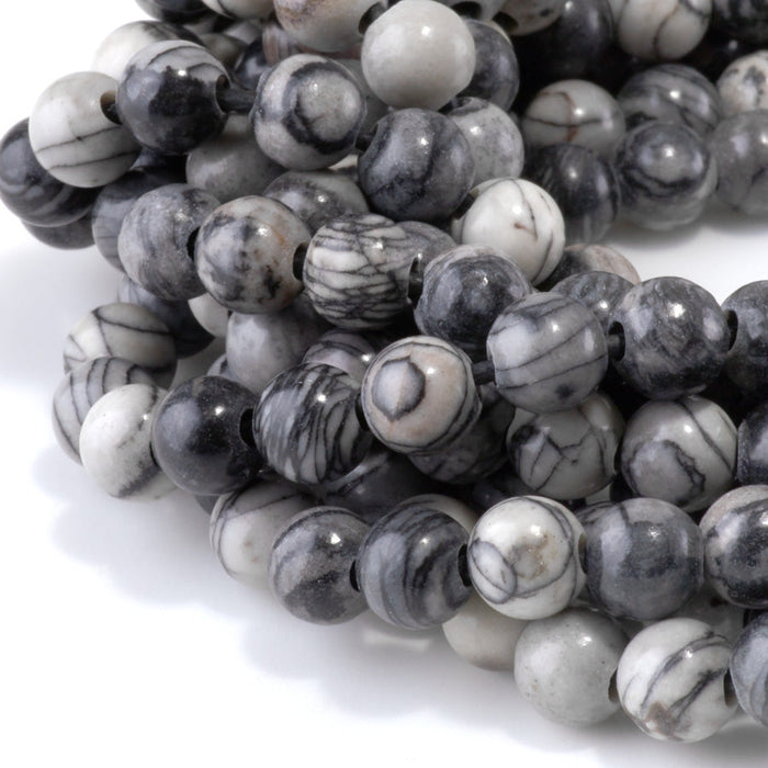 This is a Dakota Stones 8mm Black Picasso Jasper Large Hole Gemstone strand with round beads in 8 inch strand.