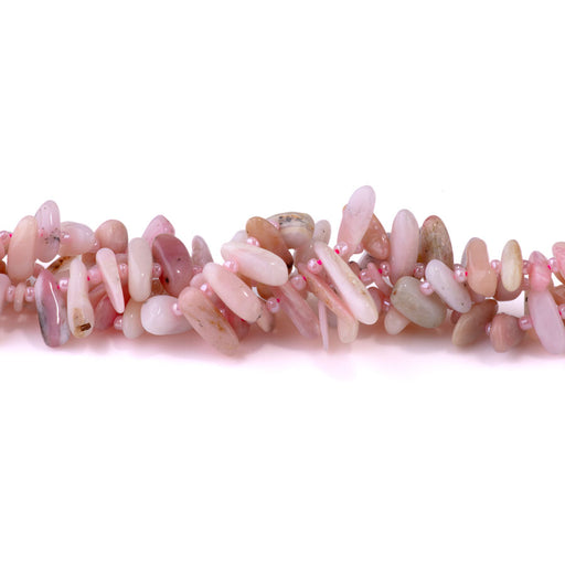 This is a Dakota Stones 5x10-20mm Pink Opal Top Drill Teeth Gemstone strand of round beads in 15-16 inch strand.