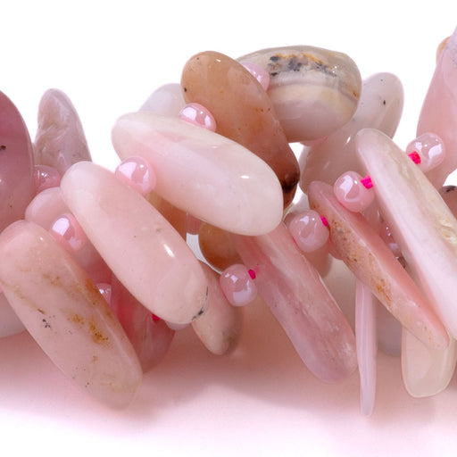 This is a Dakota Stones 5x10-20mm Pink Opal Top Drill Teeth Gemstone strand of round beads in 15-16 inch strand.