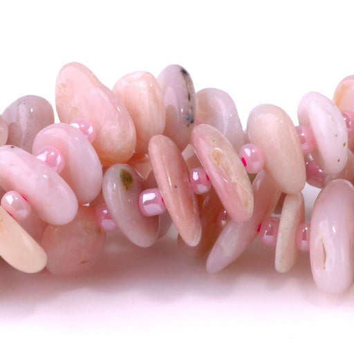 This is a Dakota Stones 5x8mm Pink Opal Gemstone strand with chip beads in 15-16 inch strand.