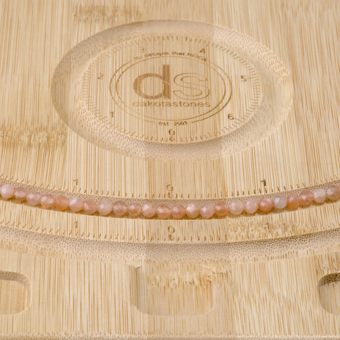 This is a Dakota Stones 4mm Peach Moonstone Gemstone strand with AA grade faceted round beads in 15-16 inch strand.