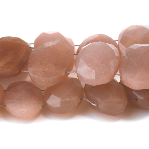 This is a Dakota Stones 9x11-13x20mm Peach Moonstone Double Drill Gemstone strand with faceted oval beads in 10 inch strand.