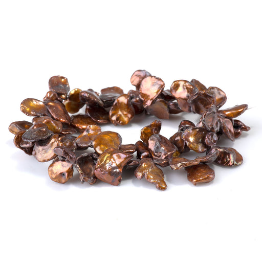 This is a Dakota Stones 11-14mm Freshwater Pearl Golden Brown Keshi Gemstone strand of round beads in 15-16 inch strand.