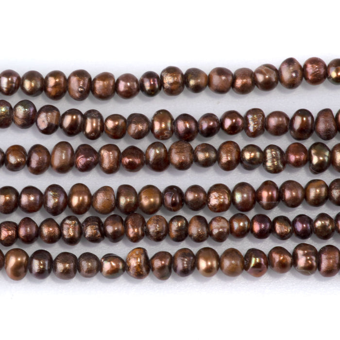 This is a Dakota Stones 5-3mm Freshwater Pearl Brown Potato Gemstone strand of round beads in 15-16 inch strand.