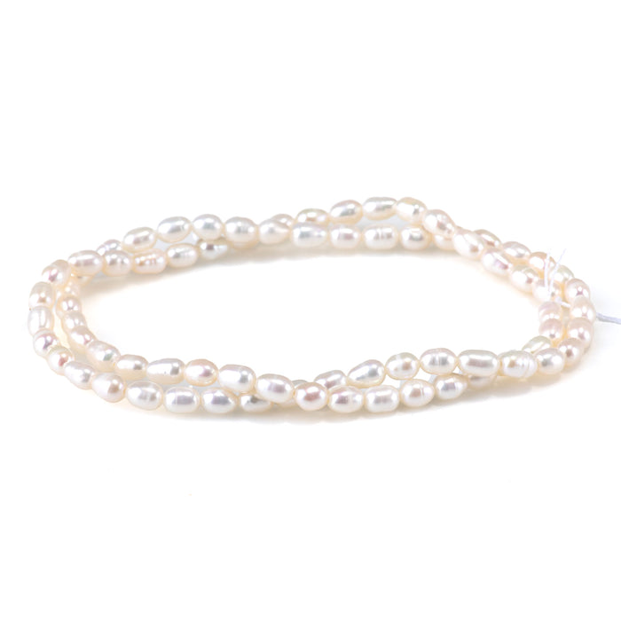 This is a Dakota Stones 4-5mm Freshwater Pearl White Rice Gemstone strand of round beads in 15-16 inch strand.