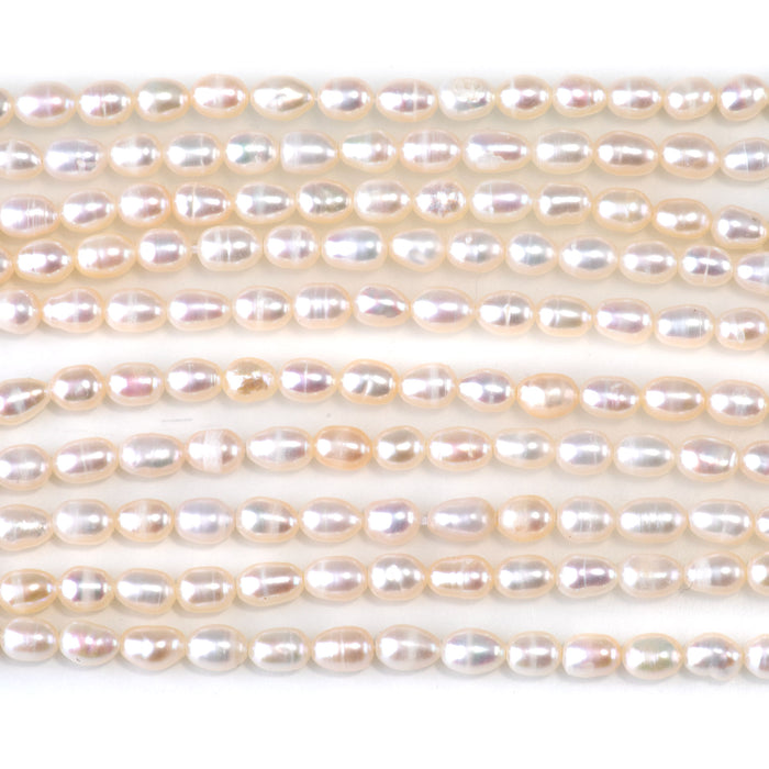 This is a Dakota Stones 4-5mm Freshwater Pearl White Rice Gemstone strand of round beads in 15-16 inch strand.