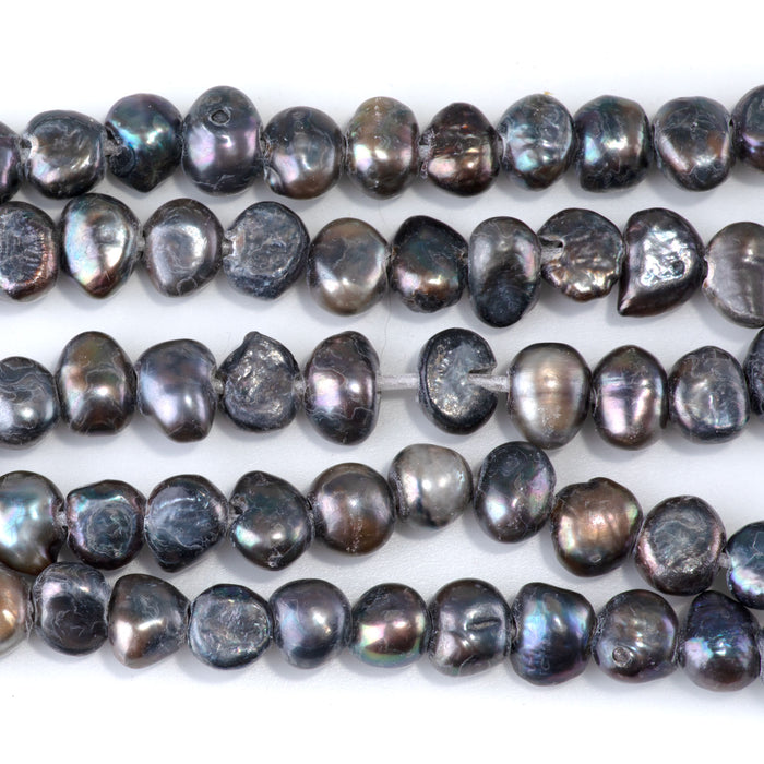This is a Dakota Stones 6-10mm Freshwater Pearl Grey Peacock Button Gemstone strand with irregular beads in 8 inch strand.