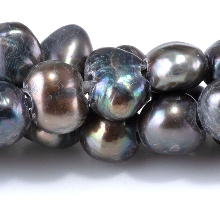 This is a Dakota Stones 6-10mm Freshwater Pearl Grey Peacock Button Gemstone strand with irregular beads in 8 inch strand.