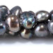 This is a Dakota Stones 6-10mm Freshwater Pearl Grey Peacock Button Gemstone strand with irregular beads in 8 inch strand.