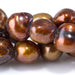 This is a Dakota Stones 7-12mm Freshwater Pearl Golden Brown Button Gemstone strand with irregular beads in 8 inch strand.