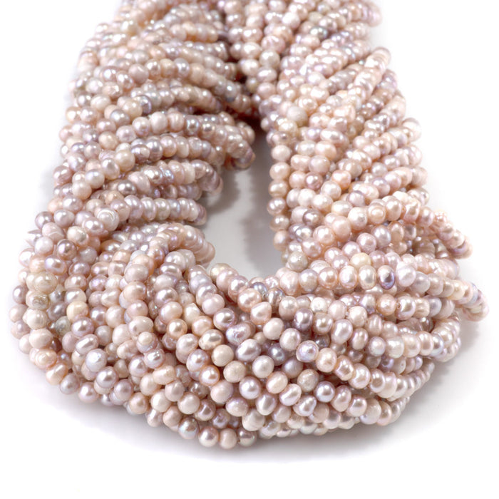 This is a Dakota Stones 3x4mm Special Price Freshwater Pearl strand with pink mix center drill rice beads in 13-14 inch strand.