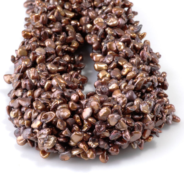 This is a Dakota Stones 5-8mm Special Price Freshwater Pearl strand with copper keshi beads in 15-16 inch strand.