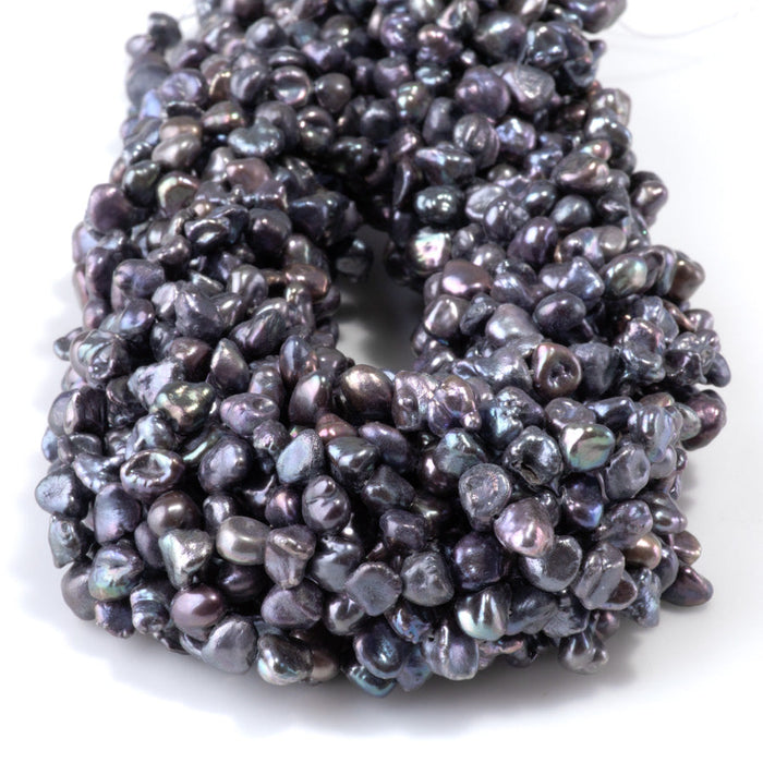 This is a Dakota Stones 5-8mm Special Price Freshwater Pearl strand with peacock keshi beads in 15-16 inch strand.