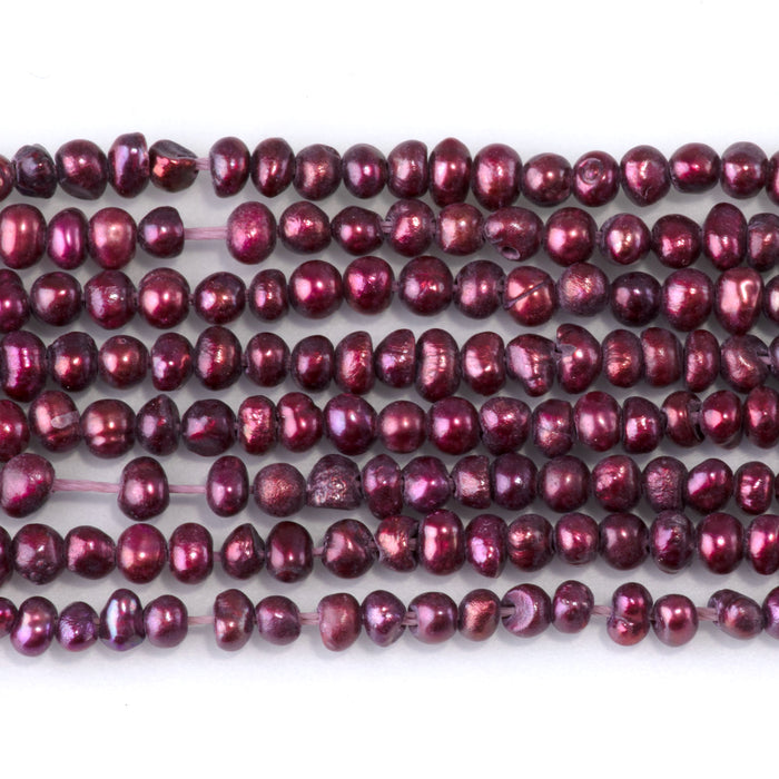 This is a Dakota Stones 5-3mm Freshwater Pearl Dark Pink Potato Gemstone strand of round beads in 15-16 inch strand.